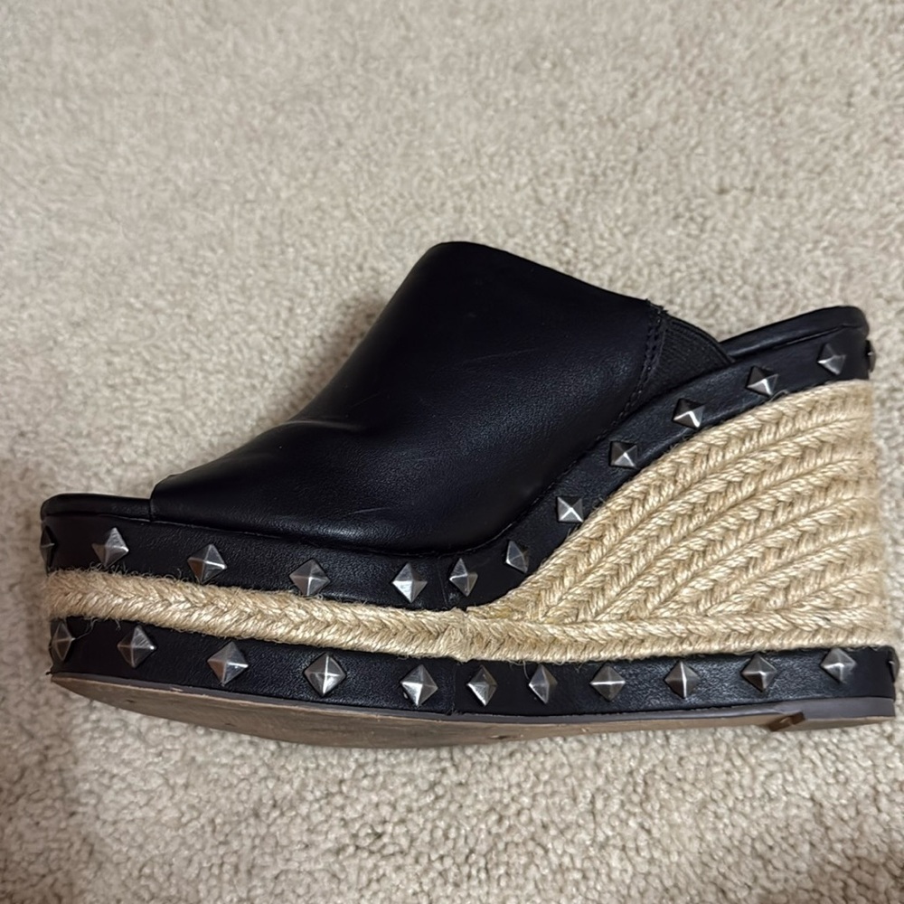 Black leather wedges with metal design.